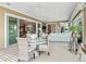 Bright sunroom featuring a dining table and a comfortable seating area with sliding glass doors at 3654 Enterprise Dr, The Villages, FL 32163