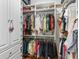 Organized walk-in closet featuring shelving, drawers, and hanging rods for ample storage at 3654 Enterprise Dr, The Villages, FL 32163