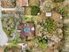 A captivating aerial perspective showcasing the property's pool, surroundings, and unique shape at 36816 Taylor Mill Rd, Fruitland Park, FL 34731