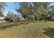 Large backyard featuring mature trees and an outbuilding at 36816 Taylor Mill Rd, Fruitland Park, FL 34731