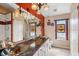 Bathroom featuring double sinks with marble countertop and decorative lighting fixtures at 36816 Taylor Mill Rd, Fruitland Park, FL 34731