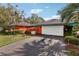 Bright home featuring attached two-car garage, lush landscaping, and vibrant exterior at 36816 Taylor Mill Rd, Fruitland Park, FL 34731