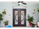 Elegant front door with decorative glass and sidelights, enhanced by lush greenery at 36816 Taylor Mill Rd, Fruitland Park, FL 34731