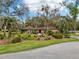 Charming single-story home featuring vibrant paint, well-manicured landscaping, and mature trees at 36816 Taylor Mill Rd, Fruitland Park, FL 34731