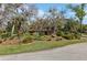 Charming single-story home featuring vibrant paint, well-manicured landscaping, and mature trees at 36816 Taylor Mill Rd, Fruitland Park, FL 34731