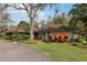 Charming home featuring vibrant landscaping and a spacious front yard that invites you to relax and enjoy outdoor living at 36816 Taylor Mill Rd, Fruitland Park, FL 34731