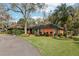 Lush front yard showcasing a well-kept lawn and a beautiful home with mature trees and attractive landscaping at 36816 Taylor Mill Rd, Fruitland Park, FL 34731