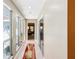 Bright hallway with glass paneled windows and sliding glass door; offering natural light and a view of the bedroom at 36816 Taylor Mill Rd, Fruitland Park, FL 34731