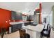 Well-equipped kitchen with granite countertops, stainless steel appliances, gray cabinetry, and cooktop island with bar seating at 36816 Taylor Mill Rd, Fruitland Park, FL 34731