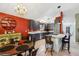 Kitchen featuring granite countertops, stainless steel appliances, gray cabinetry, cooktop island, and adjacent dining area at 36816 Taylor Mill Rd, Fruitland Park, FL 34731