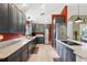 Modern kitchen with gray cabinetry, granite countertops, stainless steel appliances, and a built-in cooktop island at 36816 Taylor Mill Rd, Fruitland Park, FL 34731