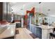 Contemporary kitchen featuring stainless steel appliances, granite countertops, gray cabinets and a kitchen island cooktop at 36816 Taylor Mill Rd, Fruitland Park, FL 34731