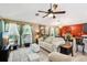 Spacious living room with ample seating, stylish decor, and seamless flow into dining area at 36816 Taylor Mill Rd, Fruitland Park, FL 34731