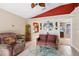 Comfortable living room with neutral tile floors and decorative mirror at 36816 Taylor Mill Rd, Fruitland Park, FL 34731