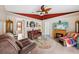 Comfortable living room with ceiling fan and fireplace at 36816 Taylor Mill Rd, Fruitland Park, FL 34731