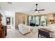 Inviting living room with neutral tones, comfortable seating, and a view into another room at 36816 Taylor Mill Rd, Fruitland Park, FL 34731