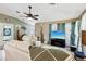 Bright living room featuring vaulted ceilings, a ceiling fan, and stylish furnishings at 36816 Taylor Mill Rd, Fruitland Park, FL 34731