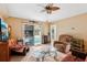 Inviting living room featuring sliding glass doors to the pool and neutral tile floors at 36816 Taylor Mill Rd, Fruitland Park, FL 34731
