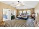 Spacious main bedroom with a high ceiling, fan, and a door leading to the en-suite bathroom at 36816 Taylor Mill Rd, Fruitland Park, FL 34731