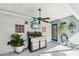Outdoor kitchen with grill, sink, ceiling fan and brick accents at 36816 Taylor Mill Rd, Fruitland Park, FL 34731
