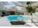 Sparkling pool with screened enclosure and lush landscaping, perfect for relaxation at 36816 Taylor Mill Rd, Fruitland Park, FL 34731