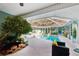 Stunning pool area with screened-in lanai, surrounded by lush greenery at 36816 Taylor Mill Rd, Fruitland Park, FL 34731
