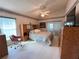 Cozy main bedroom with a ceiling fan and en-suite bath at 3824 Doune Way, Clermont, FL 34711