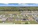 Expansive aerial view showcasing a neighborhood with well-maintained homes and green lawns at 4000 Se 98Th Pl, Belleview, FL 34420