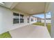Spacious covered back patio, ideal for outdoor living and entertaining with view of backyard at 4000 Se 98Th Pl, Belleview, FL 34420