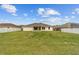 Lush backyard of this home, complete with a covered patio and white fencing at 4000 Se 98Th Pl, Belleview, FL 34420