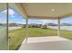 View of the grassy backyard with a storage shed, fenced in and houses nearby at 4000 Se 98Th Pl, Belleview, FL 34420