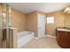 Well-lit bathroom features a soaking tub, a separate glass shower, and a granite countertop vanity at 4000 Se 98Th Pl, Belleview, FL 34420