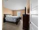 Comfortable bedroom with carpet, a TV, and great natural light from the window at 4000 Se 98Th Pl, Belleview, FL 34420