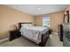 Cozy bedroom showcasing neutral walls, plush carpet, and a bright window for ample light at 4000 Se 98Th Pl, Belleview, FL 34420