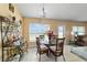 Bright dining area with glass table, wicker chairs, and decorative shelving at 4000 Se 98Th Pl, Belleview, FL 34420