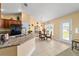 Cozy dining area features a glass table, wicker chairs, and natural light at 4000 Se 98Th Pl, Belleview, FL 34420