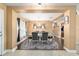 Spacious dining room featuring a modern chandelier, elegant furniture, and stylish decor at 4000 Se 98Th Pl, Belleview, FL 34420