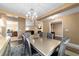 Elegant dining room is decorated with modern chandelier, stylish furniture, and decor for gatherings at 4000 Se 98Th Pl, Belleview, FL 34420