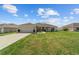 Single-story home with a well-maintained lawn and a two-car attached garage at 4000 Se 98Th Pl, Belleview, FL 34420