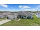 Single-story home with a well-maintained lawn and a two-car attached garage at 4000 Se 98Th Pl, Belleview, FL 34420