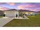 Exterior view of home featuring lush lawn and colorful sunset sky at 4000 Se 98Th Pl, Belleview, FL 34420