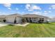 Charming single-story home with a well-manicured lawn, complemented by a two-car garage and inviting front porch at 4000 Se 98Th Pl, Belleview, FL 34420