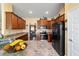 Well-lit kitchen features granite counters, stainless appliances, and eat-in counter at 4000 Se 98Th Pl, Belleview, FL 34420