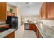 Bright kitchen with a peninsula, featuring stainless steel appliances, tile floors, and a view to the dining area at 4000 Se 98Th Pl, Belleview, FL 34420