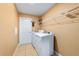 Efficient laundry area featuring a full-size washer and dryer and storage shelving at 4000 Se 98Th Pl, Belleview, FL 34420