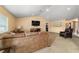 Spacious living room featuring a large couch, TV, and comfortable armchair at 4000 Se 98Th Pl, Belleview, FL 34420