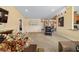 Bright living room showcasing an armchair, artwork, and view into the dining area at 4000 Se 98Th Pl, Belleview, FL 34420
