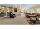 Open-concept living room with a cozy seating arrangement and views into the dining area at 4000 Se 98Th Pl, Belleview, FL 34420