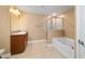 The en-suite bathroom is equipped with double sinks, a shower, and a bathtub at 4000 Se 98Th Pl, Belleview, FL 34420