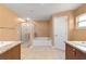 The en-suite bathroom includes double sinks, an enclosed shower, and a relaxing bathtub at 4000 Se 98Th Pl, Belleview, FL 34420